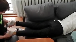 Young guy pays out his bills not far from his feet